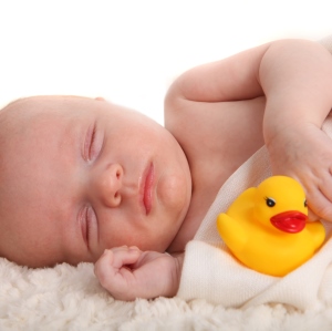 baby sleeping with rubber duck