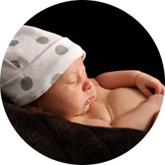 sleeping baby in spotted hat