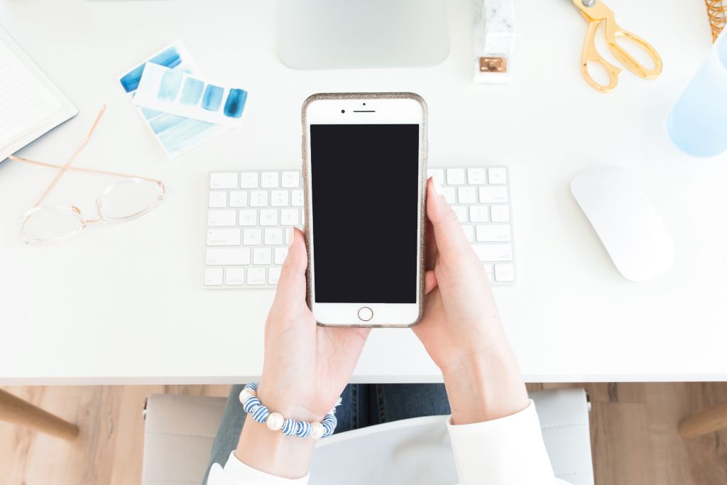 Woman looking at iphone in her hands