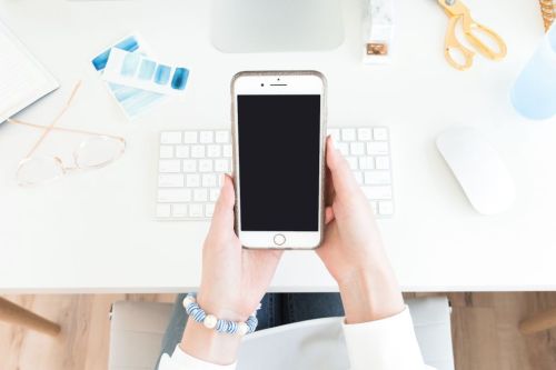 Woman looking at iphone in her hands