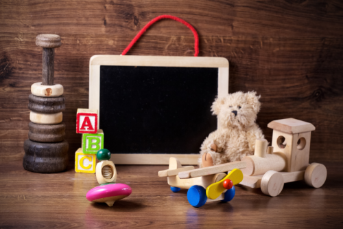 Childrens toys, teddy bear and blackboard