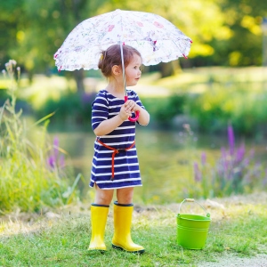 little girl with umbrella and bucket