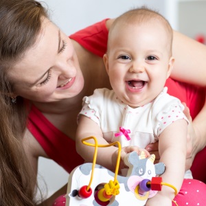 little girl laughing with toy cow