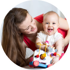 laughing baby with cow toy